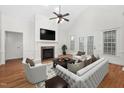 Bright living room featuring vaulted ceilings, fireplace, hardwood floors, and modern decor with lots of natural light at 4017 Olde Waverly Way, Fuquay Varina, NC 27526