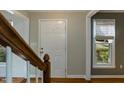 Bright foyer with hardwood floors, a staircase, and a view to the front door at 4204 New Brighton Dr, Apex, NC 27539