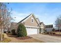 Side view of a well-maintained home with manicured lawn and mature trees at 512 Garendon Dr, Cary, NC 27519