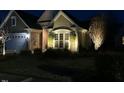 Night shot of charming home with landscape lighting, showcasing curb appeal at 512 Garendon Dr, Cary, NC 27519