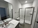 Modern bathroom with glass shower and white vanity at 526 Billingshurst Way # 211, Knightdale, NC 27545