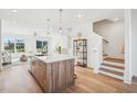 Open-concept space with staircase, kitchen island, and a cozy living area with plenty of natural light at 526 Billingshurst Way, Knightdale, NC 27545