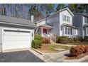 Well-maintained home with a detached garage, a red front door, and mature landscaping at 595 Weathersfield # A, Pittsboro, NC 27312