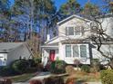 Charming home with gray siding, a bright red front door, and a detached garage at 595 Weathersfield # A, Pittsboro, NC 27312