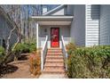 Inviting front entrance featuring a bright red door, brick steps, and white railings at 595 Weathersfield # A, Pittsboro, NC 27312