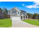 Charming two-story home with a well-kept lawn and a paved driveway at 625 Spellbrook Rd, Zebulon, NC 27597