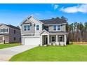 Attractive two-story home with a two-car garage and lush green lawn at 625 Spellbrook Rd, Zebulon, NC 27597