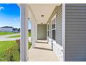 Inviting covered porch with white columns and stone accents for curb appeal at 625 Spellbrook Rd, Zebulon, NC 27597