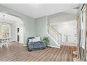 Bright living room featuring modern decor, hardwood floors, and staircase access to the upper level at 7 Indian Head Ct, Durham, NC 27703
