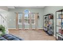 Inviting living room with a large window, wood floors, neutral walls, and a view to the outside at 7 Indian Head Ct, Durham, NC 27703