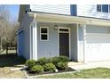 Inviting front entrance with a covered porch and craftsman-style door with sidelight at 704 Vance St, Mebane, NC 27302