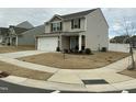 Charming two-story home features a two-car garage, stone accents, and a well-manicured front yard at 745 Little Patch St, Zebulon, NC 27597