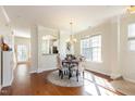 Cozy dining room with stylish chairs, chandelier, and hardwood floors at 7841 Silverthread Ln, Raleigh, NC 27617