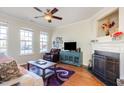 Bright living room with hardwood floors, fireplace, and large windows offering natural light at 7841 Silverthread Ln, Raleigh, NC 27617