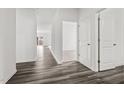 Bright hallway showcasing modern wood-look flooring, and a view of a room at the end at 805 Berkeley Glen Rd, Zebulon, NC 27597