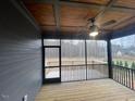 Relaxing screened porch featuring a ceiling fan and an outdoor view at 945 Lynch Rd, Selma, NC 27576