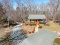 Charming exterior view with a welcoming front porch and nicely landscaped yard at 95 Blueberry Rdg, Pittsboro, NC 27312