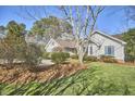 Well-maintained home with lush lawn, mature trees, and beautiful landscaping at 10 Eastwind Pl, Chapel Hill, NC 27517