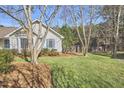 Spacious, well-manicured lawn surrounds this home, offering privacy and room to roam at 10 Eastwind Pl, Chapel Hill, NC 27517