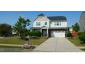 Charming two-story home with a well-maintained lawn, landscaped garden beds and a two car garage at 1001 Hope Springs Ln, Morrisville, NC 27560