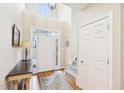 Bright foyer with hardwood floors, a staircase, a coat closet, and a soaring ceiling at 104 Barnes Spring Ct, Cary, NC 27519