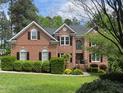 Stately brick home with manicured lawn and lush landscaping at 105 Aberson Ct, Cary, NC 27519