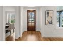 Welcoming foyer with hardwood flooring, statement artwork and views into the dining room at 109 W Markham Ave, Durham, NC 27701