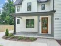 Inviting front porch with stone flooring and a beautiful wood door at 109 W Markham Ave, Durham, NC 27701