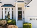 Close up view of the front door, landscaping, and bay window on a charming home at 111 Nuttree Way, Durham, NC 27713