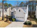 Charming two-story single Gathering home with a manicured front lawn and two car garage at 111 Nuttree Way, Durham, NC 27713