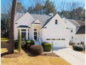Charming single Gathering home with a manicured front lawn and attached two car garage at 111 Nuttree Way, Durham, NC 27713