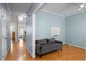 Inviting living room with hardwood floors, light blue walls, and comfortable gray couch at 12 Citation Dr, Durham, NC 27713