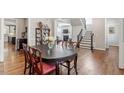 Charming dining room with hardwood floors adjacent to the staircase at 1328 Mill Glen Cir, Raleigh, NC 27614