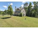 Two-story house with green lawn and mature trees in a tranquil residential neighborhood at 1328 Mill Glen Cir, Raleigh, NC 27614