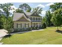 Beautiful two-story home with a well-maintained lawn, stone accents, and mature trees at 1328 Mill Glen Cir, Raleigh, NC 27614