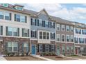 Attractive townhomes with varied siding, stone foundations, and complementary color schemes create a visually appealing streetscape at 1329 Channing Park Cir, Cary, NC 27519