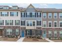 Attractive townhomes showcase a blend of stone and siding, complemented by well-maintained landscaping for added charm at 1329 Channing Park Cir, Cary, NC 27519