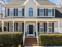 Charming two-story home with a welcoming front porch and nicely landscaped front yard at 14 Gingerwood Ln, Durham, NC 27713
