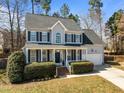Charming two-story home features a well-manicured lawn, attached garage, and classic shutters at 14 Gingerwood Ln, Durham, NC 27713