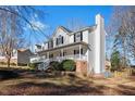 Spacious two-story home boasting a charming front porch, attached garage, and lush greenery at 15 Rocky Point Ct, Fuquay Varina, NC 27526