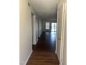 Hallway boasts sleek wood floors, leading to a bright living space with sliding glass doors at 151 Schultz St # 151, Chapel Hill, NC 27514
