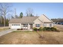 Inviting one-story home featuring a well-manicured lawn, covered entry and attached two car garage at 16 Eagle Swoop St, Zebulon, NC 27597