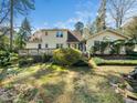 Expansive backyard featuring a wooden deck and mature trees at 1708 Lakepark Dr, Raleigh, NC 27612