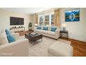 Bright living room with hardwood floors, neutral furniture, and plenty of natural light at 1708 Lakepark Dr, Raleigh, NC 27612
