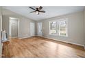 Bright living room with wood floors featuring a glass front door and several windows at 1723 Bahama Rd, Bahama, NC 27503