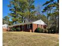 Charming single-story brick home with black shutters and a well-maintained front lawn at 1723 Lynne Ave, Henderson, NC 27536