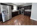 Modern kitchen with stainless steel appliances, dark wood cabinets, and a stylish backsplash at 1816 Phillips Dr, Sanford, NC 27330