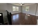 Sunlit living room featuring hardwood floors, neutral walls, and a modern ceiling fan at 1816 Phillips Dr, Sanford, NC 27330