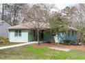 Beautifully landscaped property showcasing a well-maintained home with mature trees and greenery at 1900 Sunset Ave, Durham, NC 27705