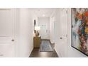 Bright hallway featuring hardwood floors, white walls, and stylish decor creates a welcoming entryway at 20 Granite Falls Way, Youngsville, NC 27596